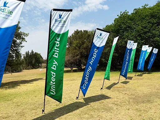 A row of telescopic banners in a field provided to a SA Birdlife event by Brand Monster.