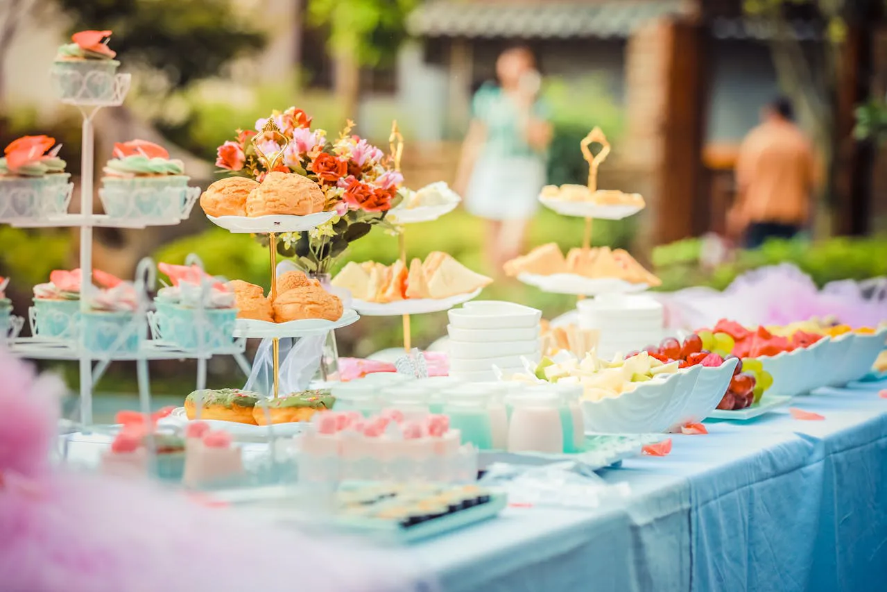 A table at an event that Brand Monster has provided branding for. The table features various cakes and desserts.